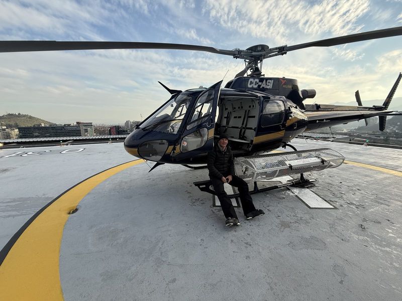 A-Star helicopter on the rooftop helipad above Santiago at the end of a ski day